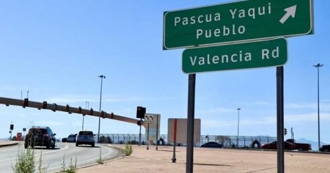 Road, Traffic Light, Road Sign. Text: Pascua Yaqui Pueblo Valencia Rd