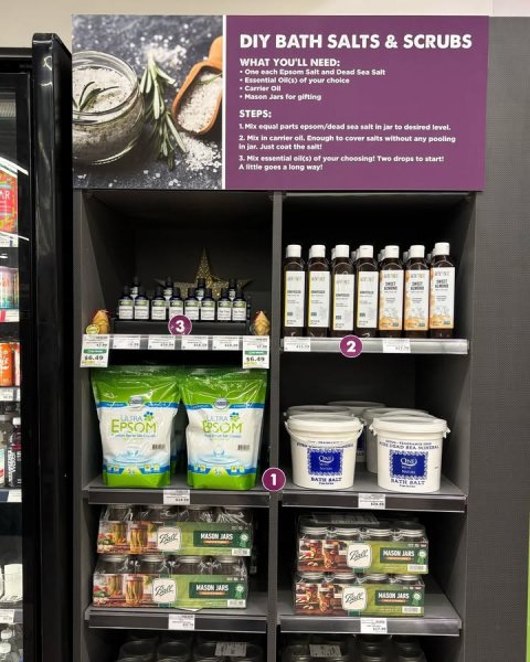 Shelf, Pantry, Shop. Text: DIY BATH SALTS &amp; SCRUBS WHAT YOU'LL NEED: One each Epsom Salt and Dead Sea Salt Carrier OF Mason Jars for gifting STEPS: 2. Mix in carrier oil, Enough to cover salts without any pooling A little goes a long way! 3 2 EXTRA EPSOM - 1