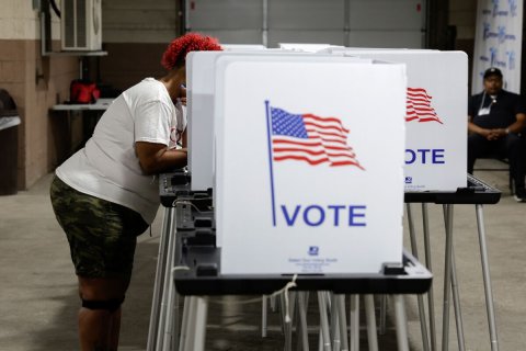 Adult, Man, Person. Text: VOTE