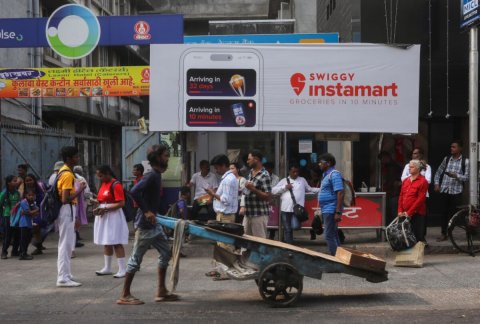 Handbag, Person, Man. Text: SWIGGY Arriving in instamart GROCERIES IN 10 MINUTES Arriving in