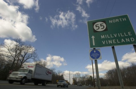 Truck, Road Sign, Sign. Text: NORTH 55 MILLVILLE VINELAND