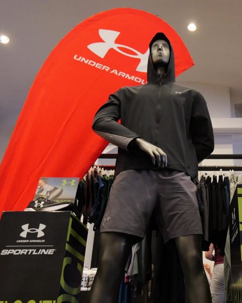 Adult, Man, Person. Text: UNDER ARMOU UNDER ARMOUR SPORTLINE