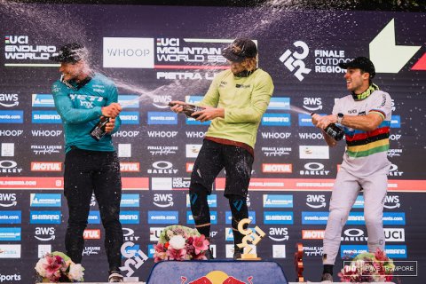 Celebrating, Person, Woman. Text: ENDURO MOUNTAIN WHOOP FINALE WORLD - aws YETI aws - WHOOP HOOP WHOOP WHO WHOOP KLEY - aws aws WS - aws aws MOTE UCI BAKLEY ports