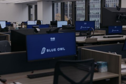 Table, Desk, Person. Text: BLUE OWL