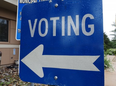 Sign, Symbol, Road Sign. Text: F A VOTING