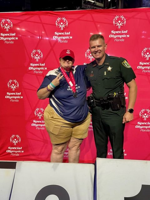 Person, Police Officer, Man. Text: Special Special Special Olympics Olympics Olympics Florida Florida Florida Spec Special Olymp Olympics Floria Florida dly Special Olympics Florida Olympi Olympi Florida Florida Special S Olympics Florida S orid