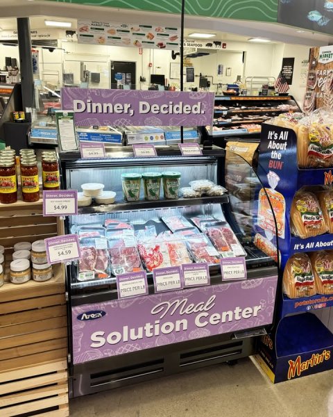 Shop, Indoors, Grocery Store. Text: MARKET FAR Dinner, Decided. EA - It's All About the BUN $4.99 54.59 It's All About Meal Solution Center
