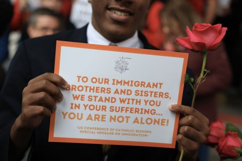 Advertisement, Rose, Poster. Text: TO OUR IMMIGRANT BROTHERS AND SISTERS, WE STAND WITH YOU IN YOUR SUFFERING... YOU ARE NOT ALONE! SPECIAL MESSAGE ON IMMIGRATION