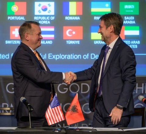Tie, Man, Person. Text: PORTUGAL REPUBLIC OF ROMANIA RW SAUDI KOREA ARABIA + SWITZERL AILAND TED ARAB ATES ted f ful Exploration of De G GOD H
