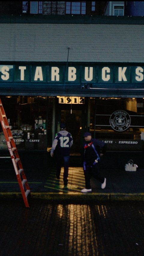 City, Street, Walking. Text: STARBUCKS STARBUCKS COFFEE TEA SPICES CCINO CAFFE 12 ATTE ESPRESSO