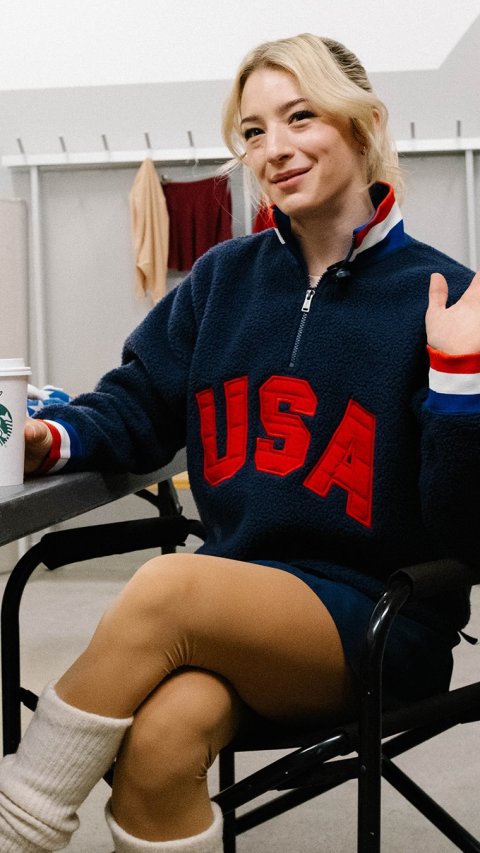 Sweater, Person, Sitting. Text: USA