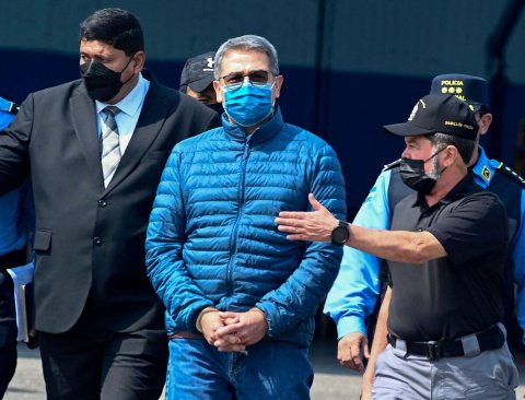 Adult, Man, Person. Text: POLICIA