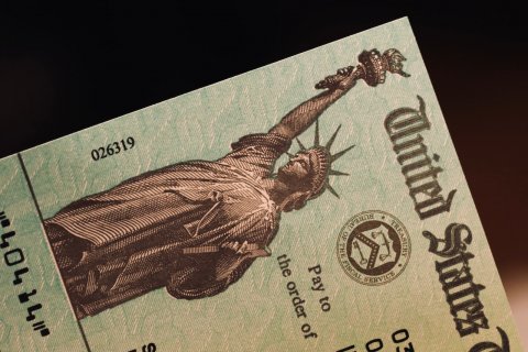Paper, Text, Person. Text: United States Pay to the order of 026319