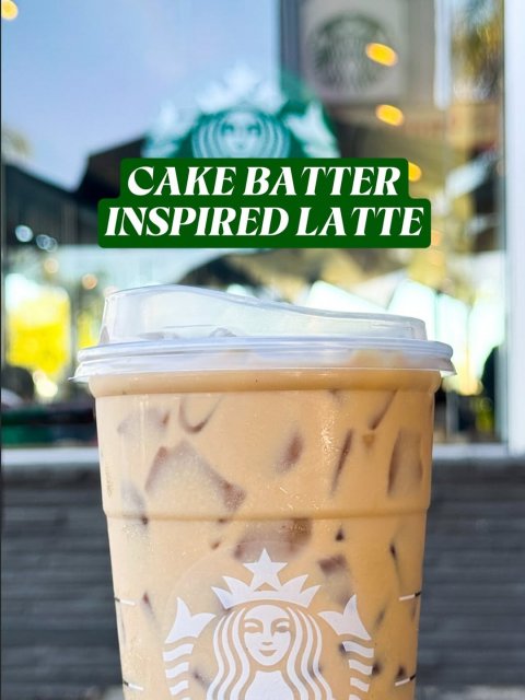 Beverage, Disposable Cup, Person. Text: CAKE BATTER INSPIRED LATTE