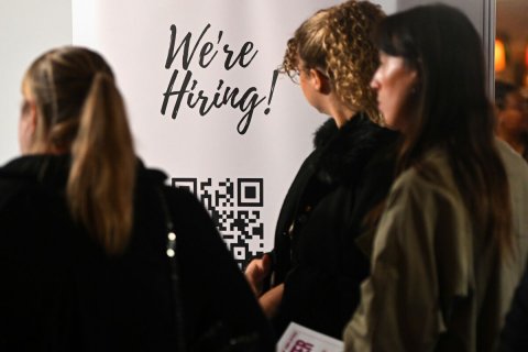 Coat, Jacket, Person. Text: We're Hiring!