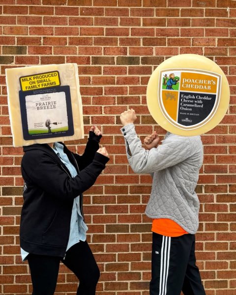 Brick, Advertisement, Poster. Text: MILK PRODUCED ON SMALL FAMILY FARMS POACHER'S CHEDDAR PRAIRIE BREEZE English Cheddar Cheese with Onion