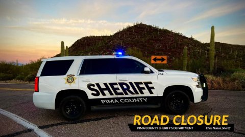 Car, Police Car, Vehicle. Text: SHERIFF PIMA COUNTY ROAD CLOSURE PIMA COUNTY SHERIFF'S DEPARTMENT