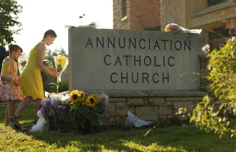 Tomb, Gravestone, Person. Text: ANNUNCIATION CATHOLIC CHURCH