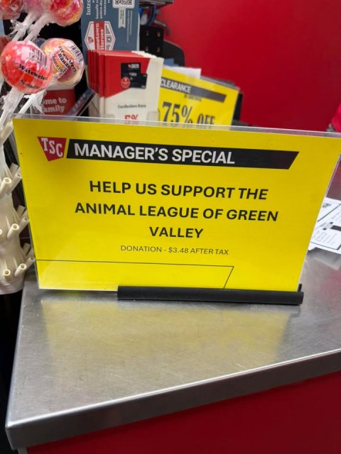 Advertisement, Sweets, Poster. Text: Heroes CLEARANCE me to 75% OFF TSC MANAGER'S SPECIAL HELP US SUPPORT THE ANIMAL LEAGUE OF GREEN VALLEY DONATION - $3.48 AFTER TAX