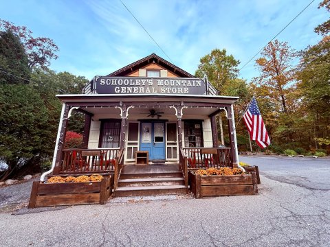 Housing, Porch, Flag. Text: SCHOOLEY'S MOUNTAIN GENERAL STORE