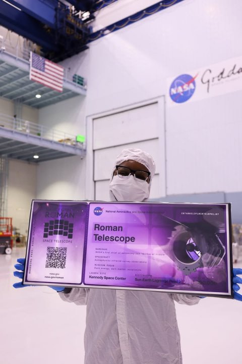 Advertisement, Glasses, Person. Text: NASA NASA ROMAN Roman Telescope SPACE TELESCOPE Kennedy Space Center