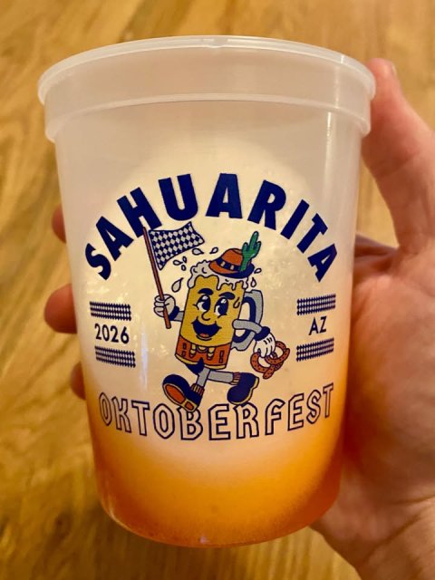 Beverage, Disposable Cup, Person. Text: 2026 AZ OKTOBERFEST