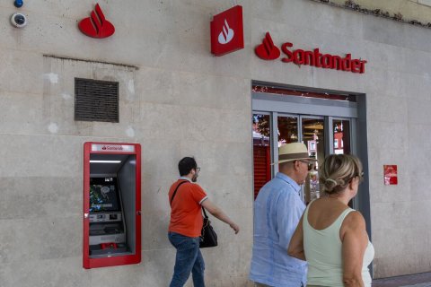 Adult, Person, Woman. Text: Santander