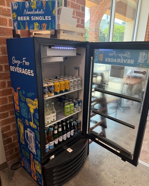 Device, Refrigerator, Person. Text: Nonalcoholic BEER SINGLES BEVERAGES ADM