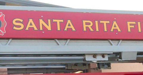 Sign, Symbol, Vehicle. Text: SANTA RITA FI
