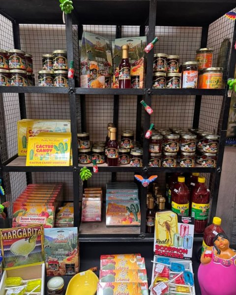 Shelf, Pantry, Person. Text: CACTUS CANDY CA - MARGARITA Real! SCORPION SUCKERS