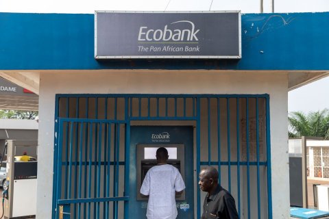Adult, Man, Person. Text: Ecobank The Pan African Bank DAME Ecobank